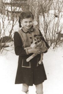 Photograph of Erika Vermes and her puppy in the snow c. 1940-41 in Topolcany, Slovakia.