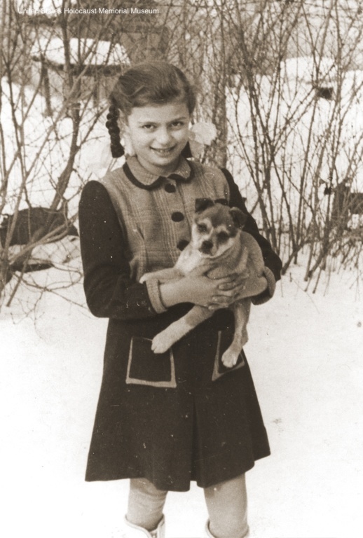 Photograph of Erika Vermes and her puppy in the snow c. 1940-41 in Topolcany, Slovakia.