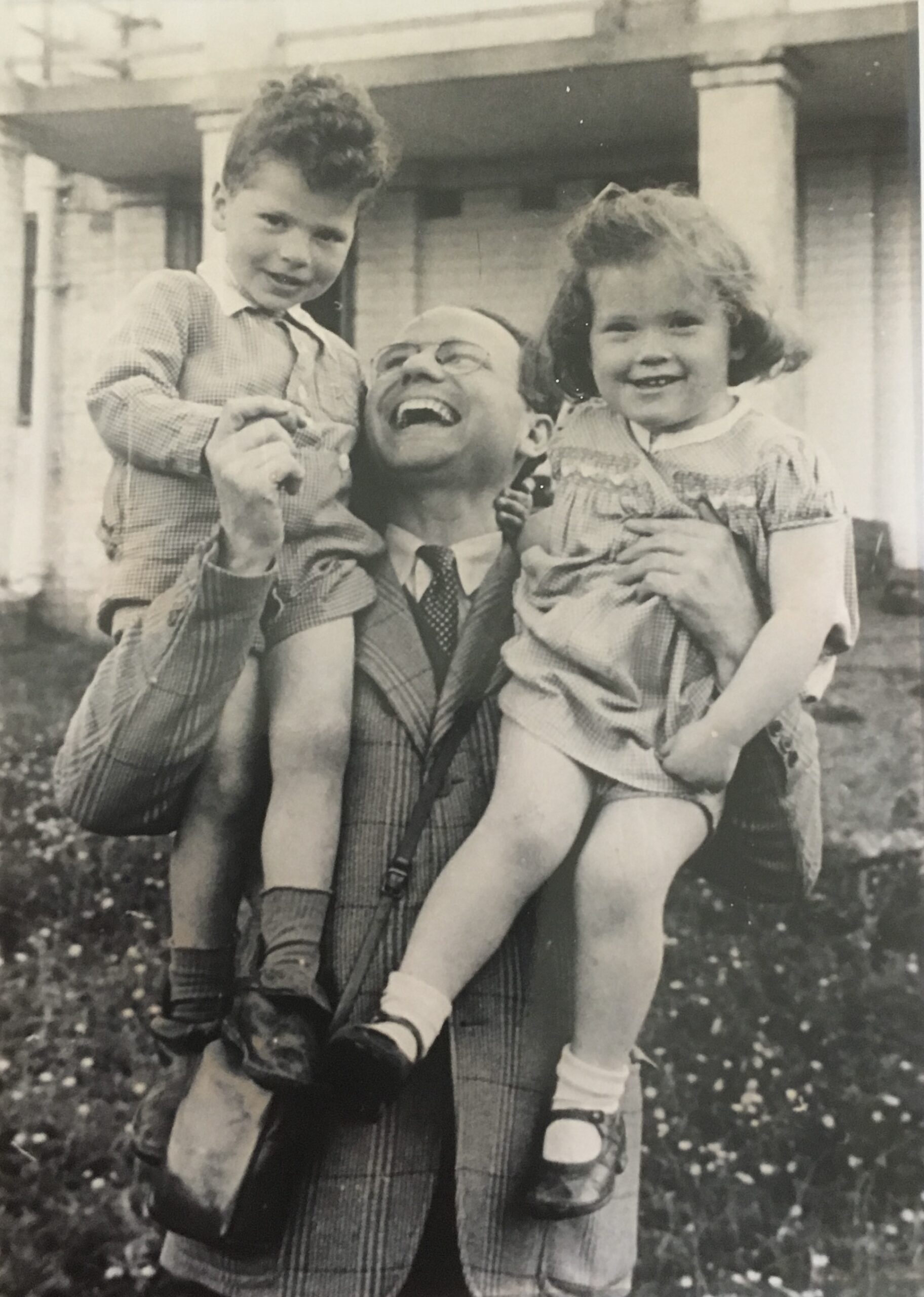 Photograph of Two of the children with a visiting journalist.