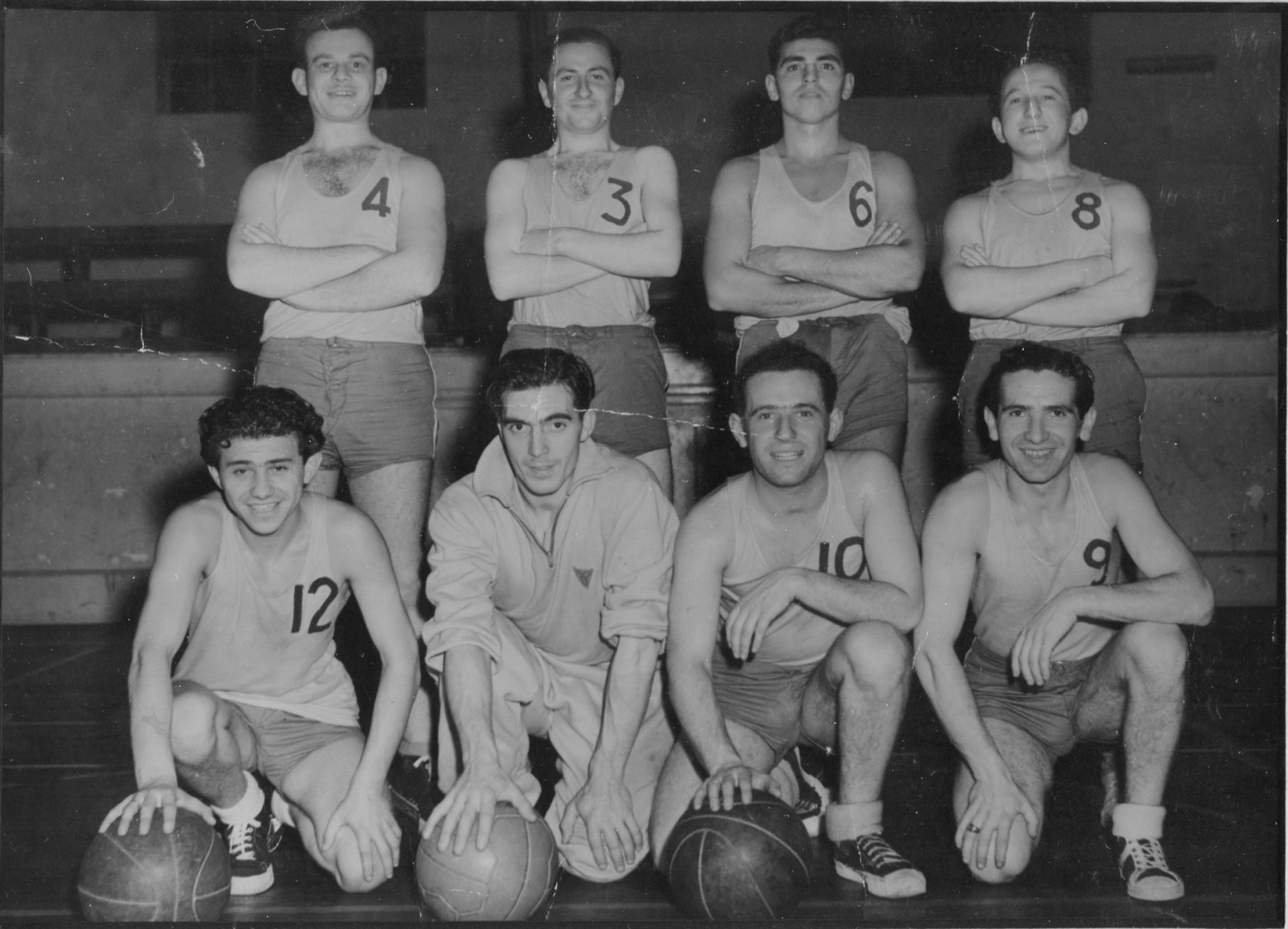 Primrose Club basket ball team, London, 1947. Team member in shirt numbers: David Herman (6), Harry Fox (8), Zigi Shipper (12), coach Freddy Johnson, Nat Wald (10) & Michael Preston (9).