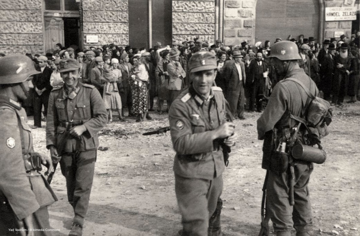 Photograph of German soldiers guarding a group of Jews in Sanok, Poland, 1 September 1939.