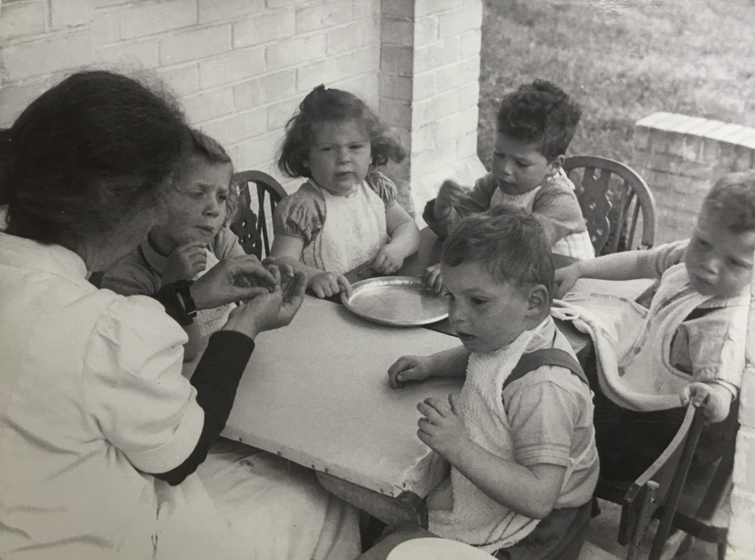 Photograph of the children eating outdoors.