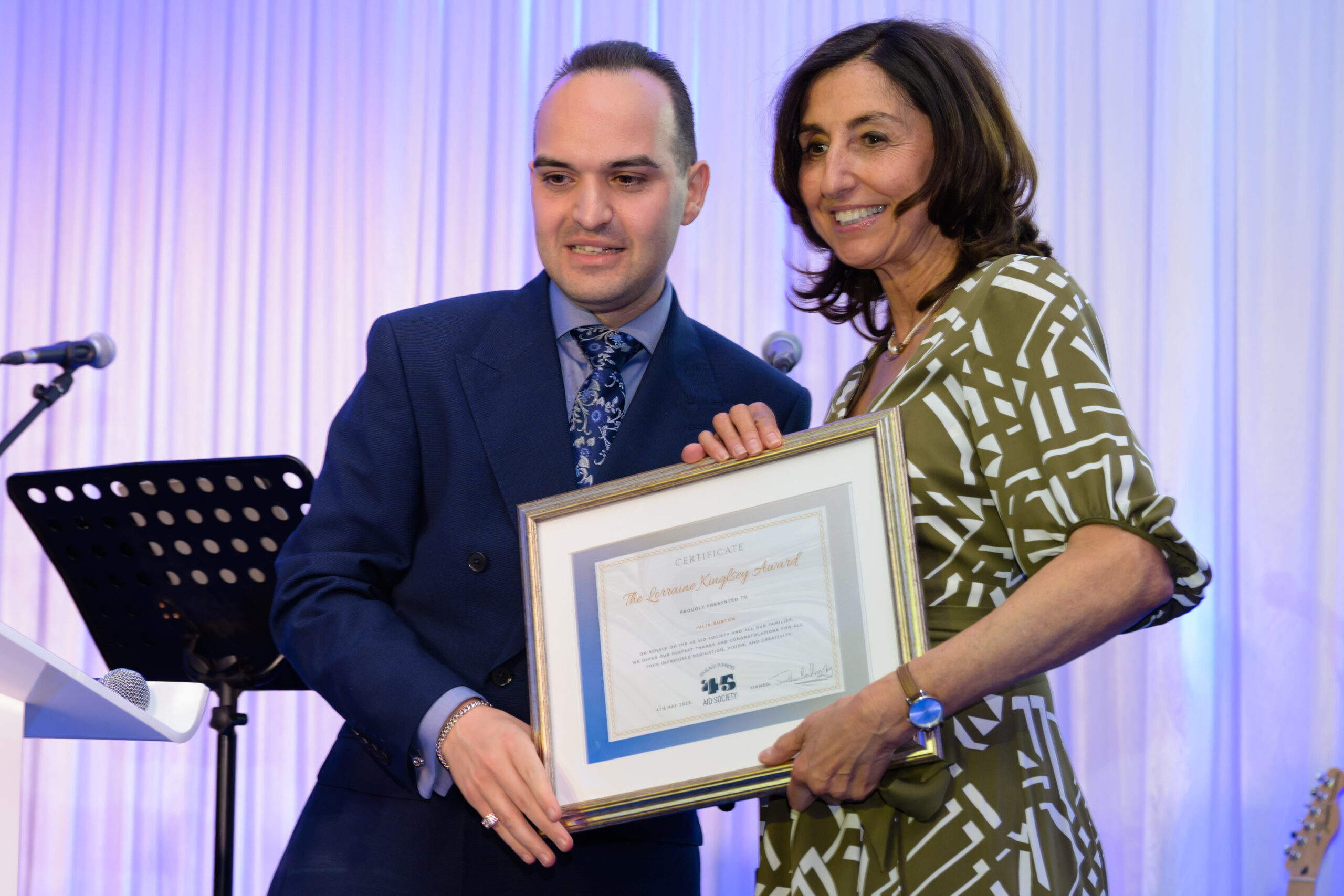 Photograph of Jonathan Kingsley presenting the Lorraine Kingsley Award to Julia Burton.
