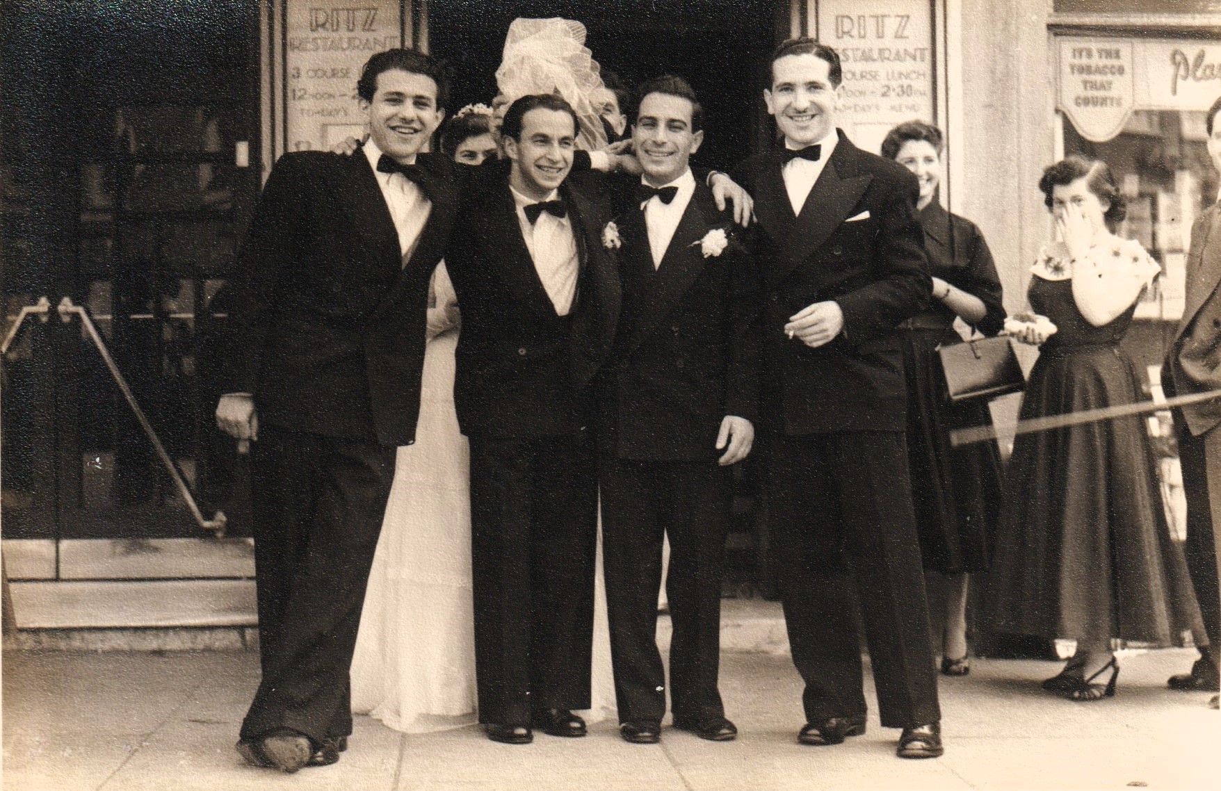 Photograph of Zigi Shipper, Krulik Wilder, Janek Goldberger, Michael Preston and Olive Herman smiling in background